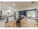 Open concept living room with modern kitchen, hardwood floors, and built-in entertainment area at 6394 Wood Valley Rd, Douglasville, GA 30134