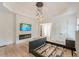 Spacious bedroom features tray ceiling, modern fireplace and lighting fixture, and an empty bed frame at 6394 Wood Valley Rd, Douglasville, GA 30134