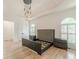 Spacious bedroom features tray ceiling, shuttered windows and modern lighting fixture, and an empty bed frame at 6394 Wood Valley Rd, Douglasville, GA 30134