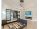 Spacious bedroom features tray ceiling, modern fireplace and lighting fixture, and an empty bed frame at 6394 Wood Valley Rd, Douglasville, GA 30134