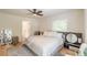 Bright bedroom features hardwood floors, ceiling fan, large mirror, and comfortable seating area at 6394 Wood Valley Rd, Douglasville, GA 30134
