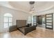 Spacious bedroom features tray ceiling, modern lighting fixture, and an empty bed frame at 6394 Wood Valley Rd, Douglasville, GA 30134