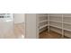 Walk-in pantry with custom shelving for ample storage space at 6394 Wood Valley Rd, Douglasville, GA 30134