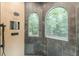Elegant shower featuring marble walls, wall shower, and large windows that provide lots of light at 6394 Wood Valley Rd, Douglasville, GA 30134