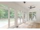 Bright sunroom with floor-to-ceiling windows offering views of the backyard at 6394 Wood Valley Rd, Douglasville, GA 30134