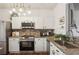 Updated kitchen featuring granite countertops, stainless steel appliances, and tiled backsplash at 1911 Stancrest Nw Trce, Kennesaw, GA 30152