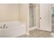 Clean bathroom with a separate tub and glass-doored shower at 2725 Morgan Glen Rd, Buford, GA 30519