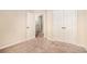 Carpeted bedroom with a hallway view and closet doors at 2725 Morgan Glen Rd, Buford, GA 30519