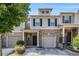 Charming townhome featuring a brick facade, gray siding, and attached one-car garage at 2725 Morgan Glen Rd, Buford, GA 30519