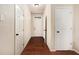 Inviting hallway featuring gleaming hardwood floors and neutral paint at 2725 Morgan Glen Rd, Buford, GA 30519
