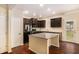 Well-lit kitchen featuring an island, granite countertops, and stainless steel appliances at 2725 Morgan Glen Rd, Buford, GA 30519