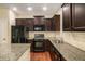 Kitchen features dark cabinets and modern appliances with ample countertop space at 2725 Morgan Glen Rd, Buford, GA 30519