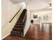 Open living room with hardwood floors, stairs, and a peek into the kitchen at 2725 Morgan Glen Rd, Buford, GA 30519