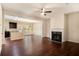 Living room with fireplace, hardwood floors, and open layout to dining area at 2725 Morgan Glen Rd, Buford, GA 30519