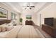 Serene main bedroom with tray ceiling, neutral colors, and a ceiling fan at 2725 Morgan Glen Rd, Buford, GA 30519