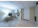 Finished basement with shelving, carpeted floors and access to outside through a white door at 3300 Wiltshire Dr, Avondale Estates, GA 30002