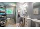 Bathroom featuring neutral walls, tiled floors, a vanity with dual sinks, shelving, and a window at 3300 Wiltshire Dr, Avondale Estates, GA 30002