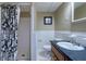 Traditional bathroom with white tile, black accents, and a shower with floral curtain at 3300 Wiltshire Dr, Avondale Estates, GA 30002