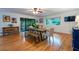 Open dining room with hardwood floors, slider to sunroom, modern table and chair set, and a large window at 3300 Wiltshire Dr, Avondale Estates, GA 30002