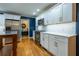 Modern kitchen with white cabinets, stainless steel appliances, and hardwood floors at 3300 Wiltshire Dr, Avondale Estates, GA 30002