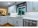 Well-lit kitchen with white countertops, a stainless steel sink, and modern fixtures at 3300 Wiltshire Dr, Avondale Estates, GA 30002