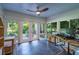 Sunroom with tile floors, lots of windows, ceiling fan and access to the backyard at 3300 Wiltshire Dr, Avondale Estates, GA 30002