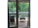 Close up of balcony with outdoor seating and views of lush green trees at 3515 Shepherds Path, Decatur, GA 30034
