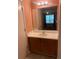 Bathroom vanity with a mirror over white countertop and wood cabinets at 3515 Shepherds Path, Decatur, GA 30034