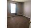Cozy bedroom featuring a window and neutral-colored carpet at 3515 Shepherds Path, Decatur, GA 30034