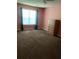 Bedroom featuring large window, neutral carpet and salmon-colored walls at 3515 Shepherds Path, Decatur, GA 30034