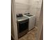 Well-lit laundry room features a modern washer and dryer and shelving units for ample storage space at 3515 Shepherds Path, Decatur, GA 30034