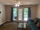 Cozy living room with natural light, fan, and a blue sofa near a window overlooking trees at 3515 Shepherds Path, Decatur, GA 30034