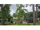 This backyard offers a stone picnic table, bird feeder, mature trees, and fenced perimeter at 529 Valley Woods Se Cir, Conyers, GA 30094