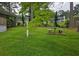 This level backyard features a stone picnic table and manicured landscaping at 529 Valley Woods Se Cir, Conyers, GA 30094