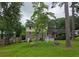 This spacious backyard offers a stone picnic table, bird feeder, mature trees, and fenced perimeter at 529 Valley Woods Se Cir, Conyers, GA 30094