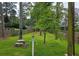 This backyard features a stone picnic table, bird feeder, mature trees, and fenced perimeter at 529 Valley Woods Se Cir, Conyers, GA 30094
