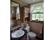 Cozy half bathroom with wallpaper, traditional vanity, and decor at 529 Valley Woods Se Cir, Conyers, GA 30094