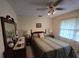Relaxing bedroom featuring a dresser with a mirror, and side tables with lamps at 529 Valley Woods Se Cir, Conyers, GA 30094