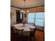This dining room features a chandelier, large windows, and a circular table with seating for six at 529 Valley Woods Se Cir, Conyers, GA 30094