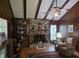 Wood-paneled living room featuring a brick fireplace and beam ceiling at 529 Valley Woods Se Cir, Conyers, GA 30094