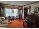 Comfortable living room with orange carpet, vintage furniture, and bright natural light at 529 Valley Woods Se Cir, Conyers, GA 30094