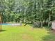 Lush backyard with pool, trampoline, fire pit, and green grass. Perfect for outdoor fun! at 250 Daileys Plantation Dr, Mcdonough, GA 30253