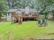 Expansive backyard with a two-story deck, stairs, and swing bench at 250 Daileys Plantation Dr, Mcdonough, GA 30253