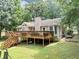 The home's backyard features an elevated deck and large green space at 250 Daileys Plantation Dr, Mcdonough, GA 30253