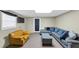 Finished basement with a yellow chair, large couch, and recessed lighting at 250 Daileys Plantation Dr, Mcdonough, GA 30253