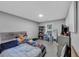 Bright bedroom featuring a gray bed frame, bookshelf, and comfortable space at 250 Daileys Plantation Dr, Mcdonough, GA 30253