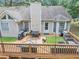 The home's backyard features an elevated deck with seating, a grill, and string lights at 250 Daileys Plantation Dr, Mcdonough, GA 30253