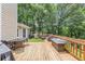 Large deck with outdoor seating, grill, and greenery. String lights overhead add ambience at 250 Daileys Plantation Dr, Mcdonough, GA 30253