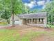 Inviting home with a covered porch, attached garage, and a well-maintained lawn at 250 Daileys Plantation Dr, Mcdonough, GA 30253