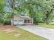 Traditional home with a long driveway, a covered porch, and a two-car garage at 250 Daileys Plantation Dr, Mcdonough, GA 30253